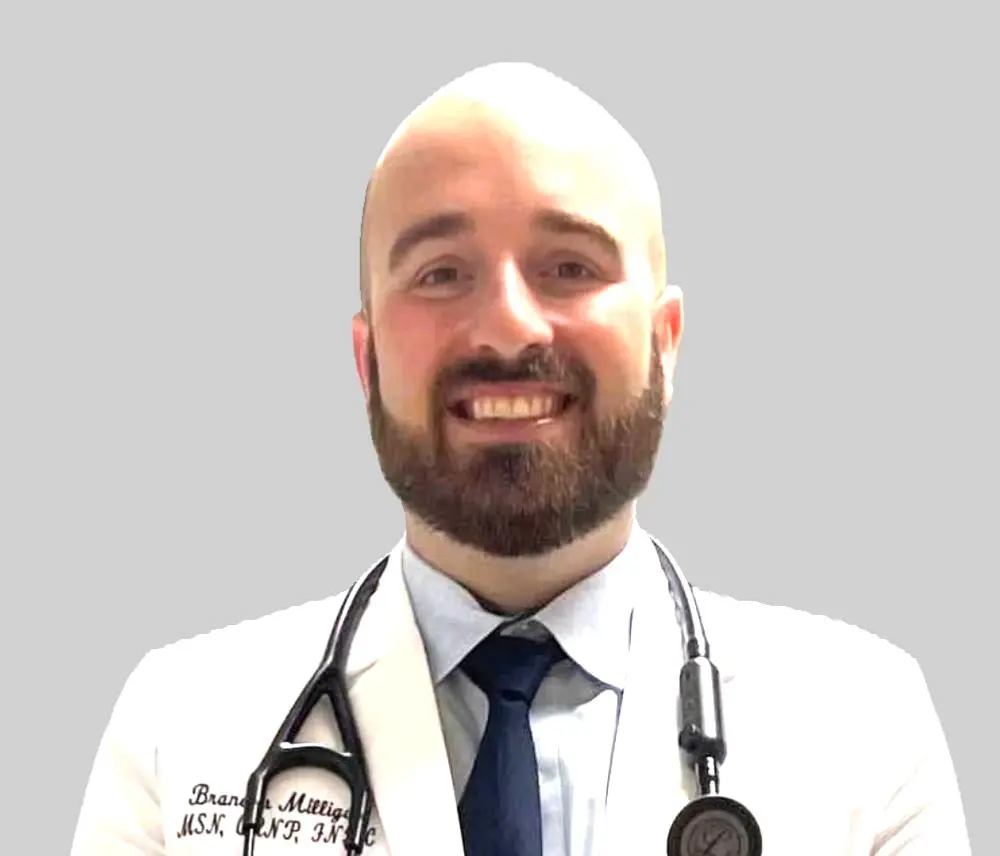 A man in white coat and tie with stethoscope.