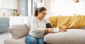 Woman measuring blood pressure at home